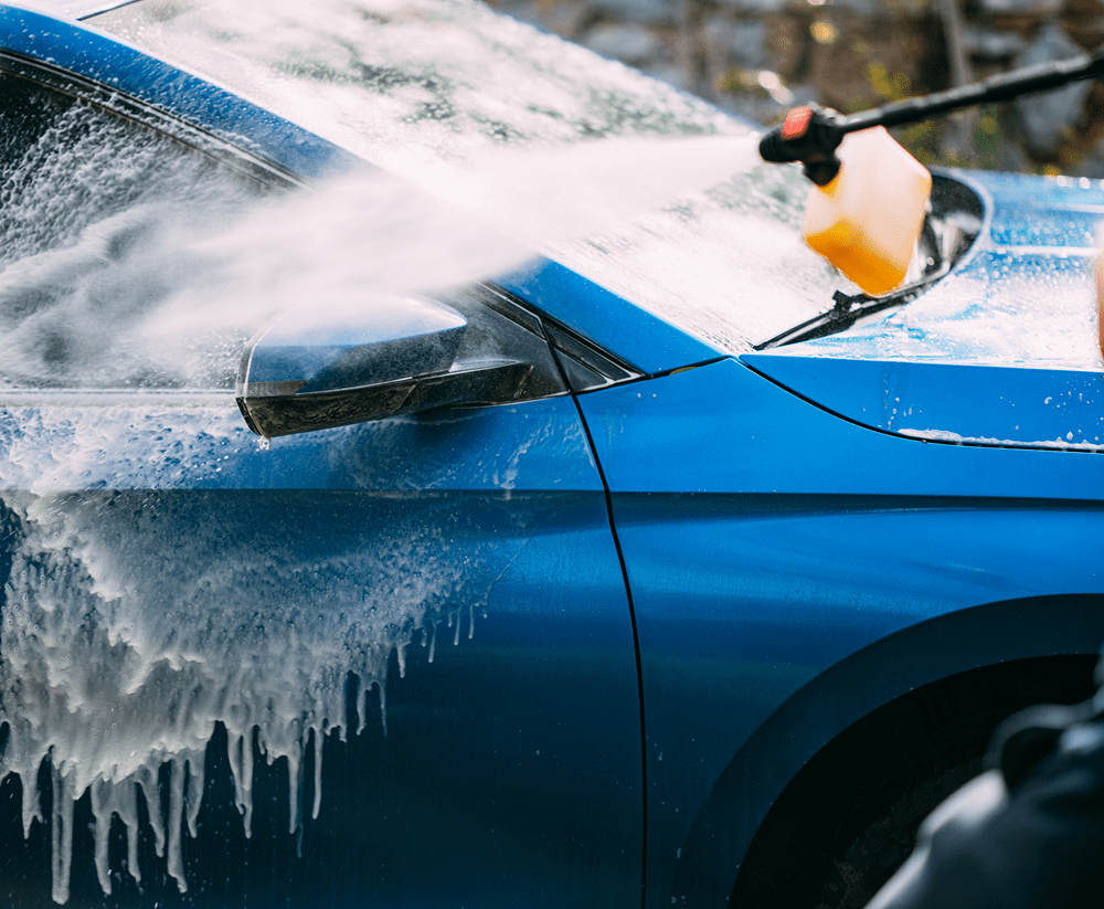 Washing car with water spray nozzle