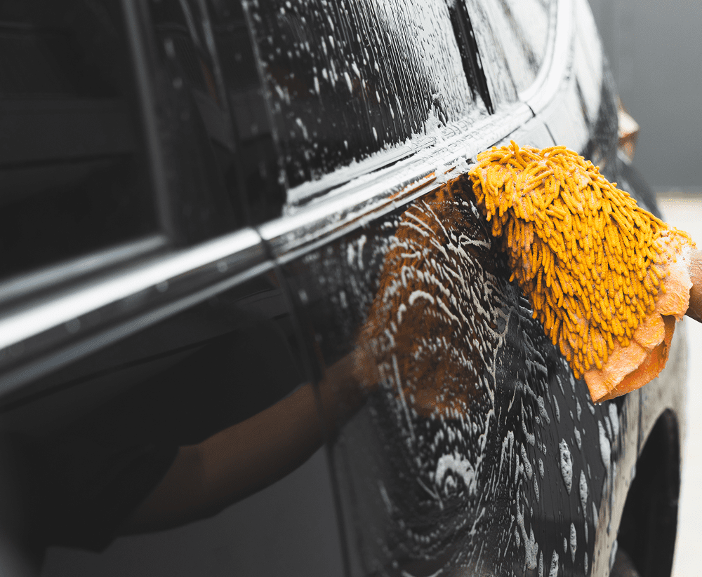 Cleaning car exterior with soap